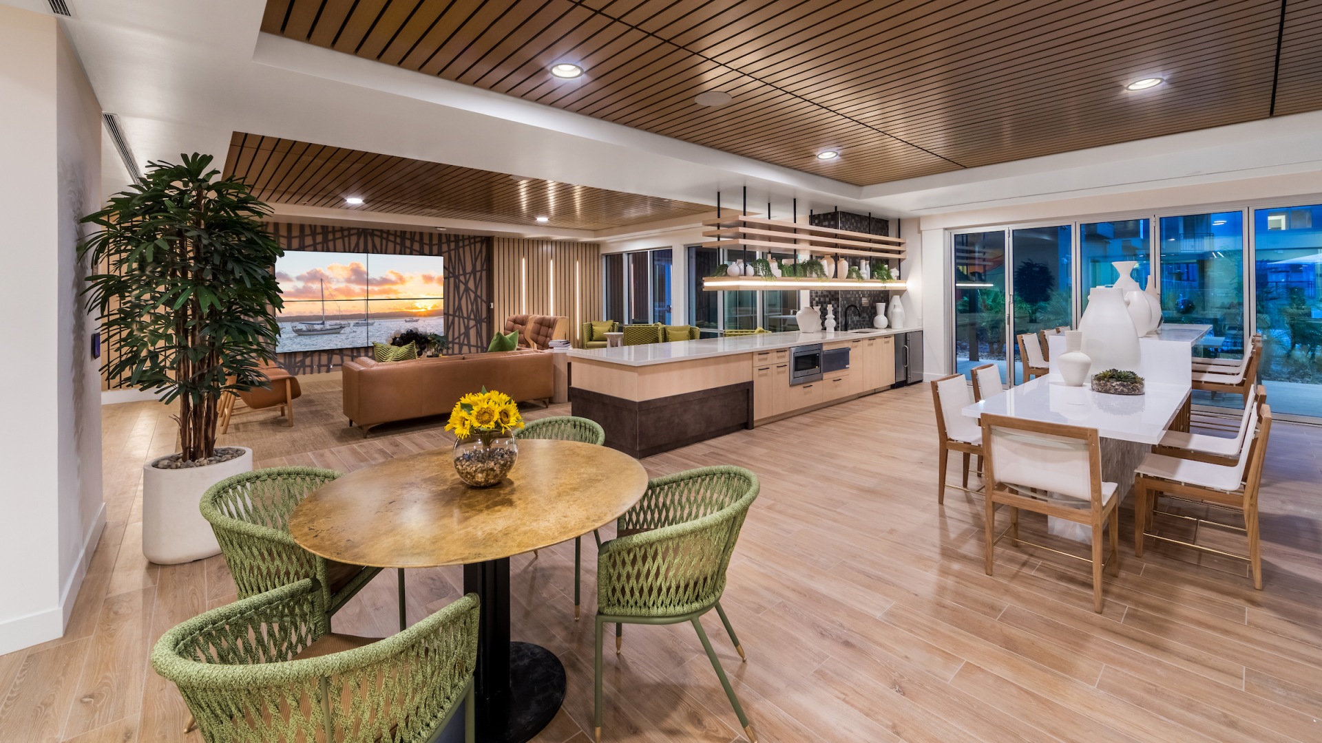 Resident cafe at our apartments for rent in Phoenix, featuring wood grain floor paneling and ample seating.