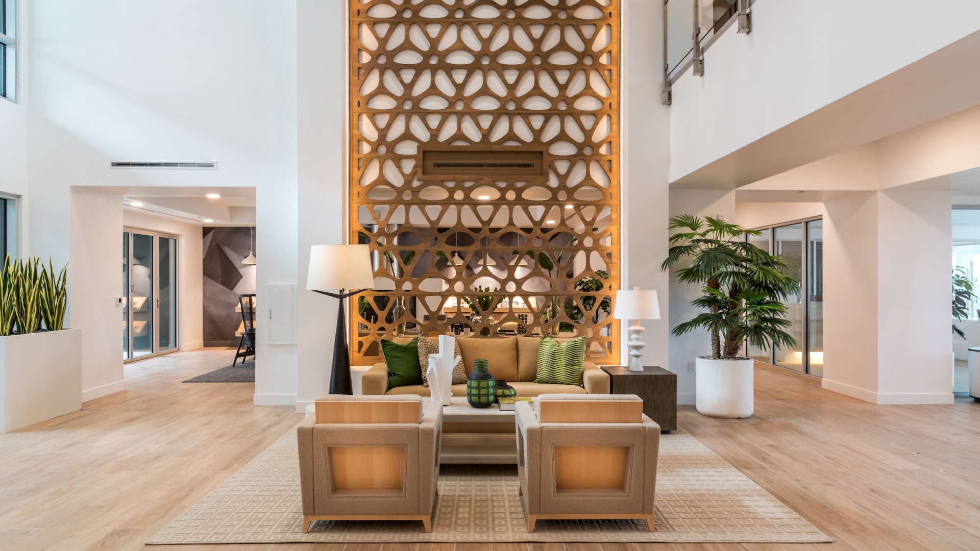 Resident lounge at our apartments for rent in Phoenix, featuring wood grain floor paneling and ample seating.